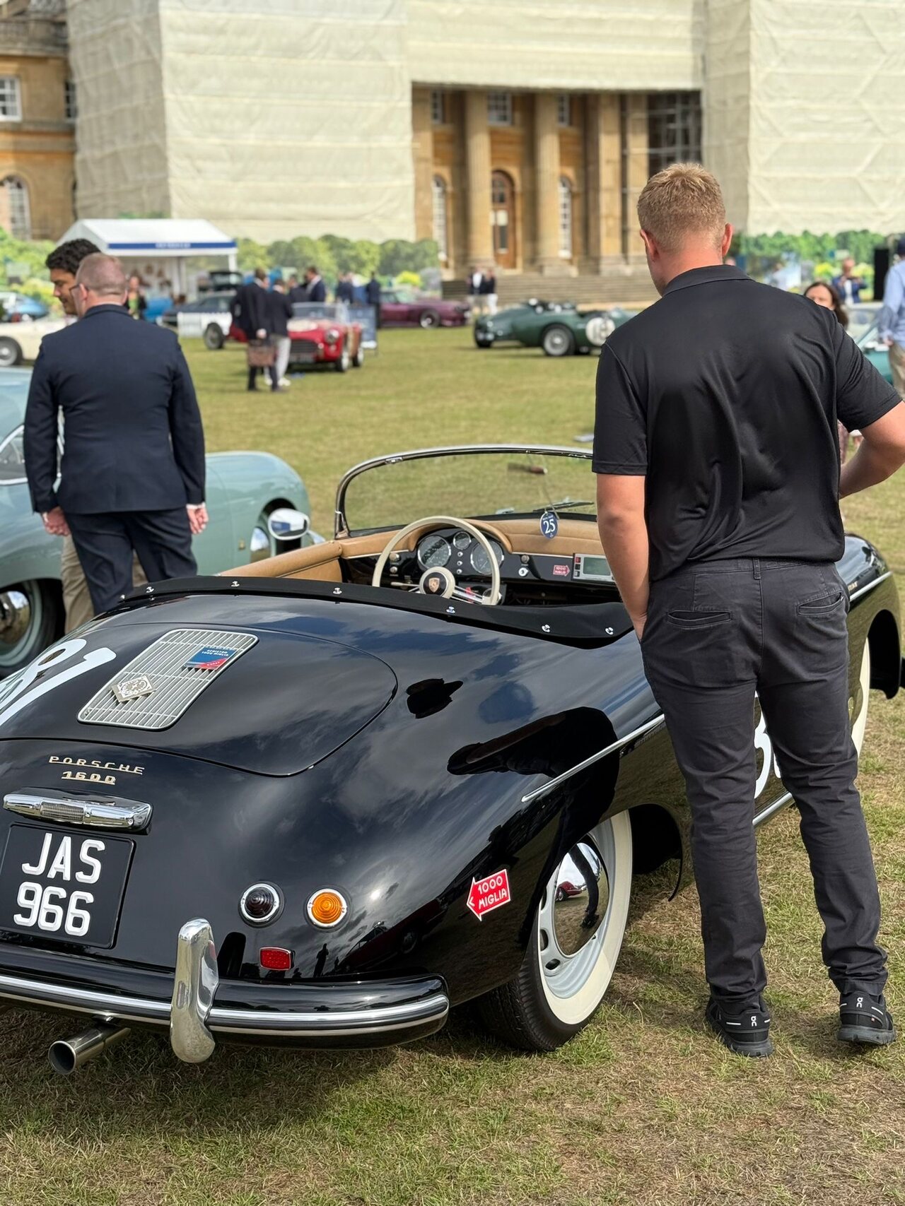 Black classic Porsche 1600 convertible at an outdoor car event